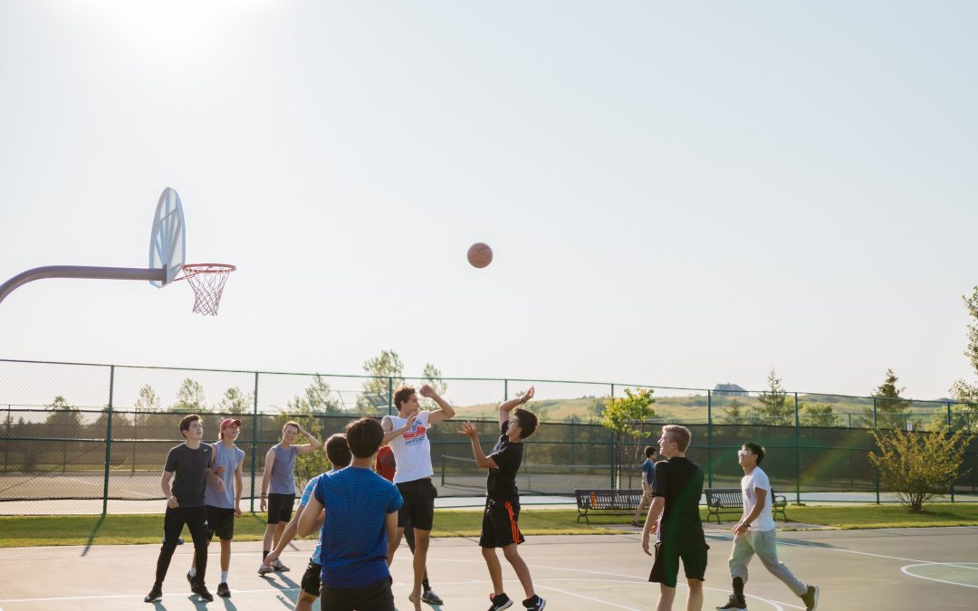 teens playing basketball